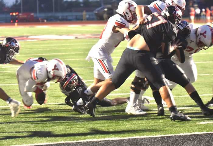 Mustang safety Zach Warren (next to right) helps make a stop on fourth-and-goal during the Broncos' win against Yukon on Sept. 22, 2023.
